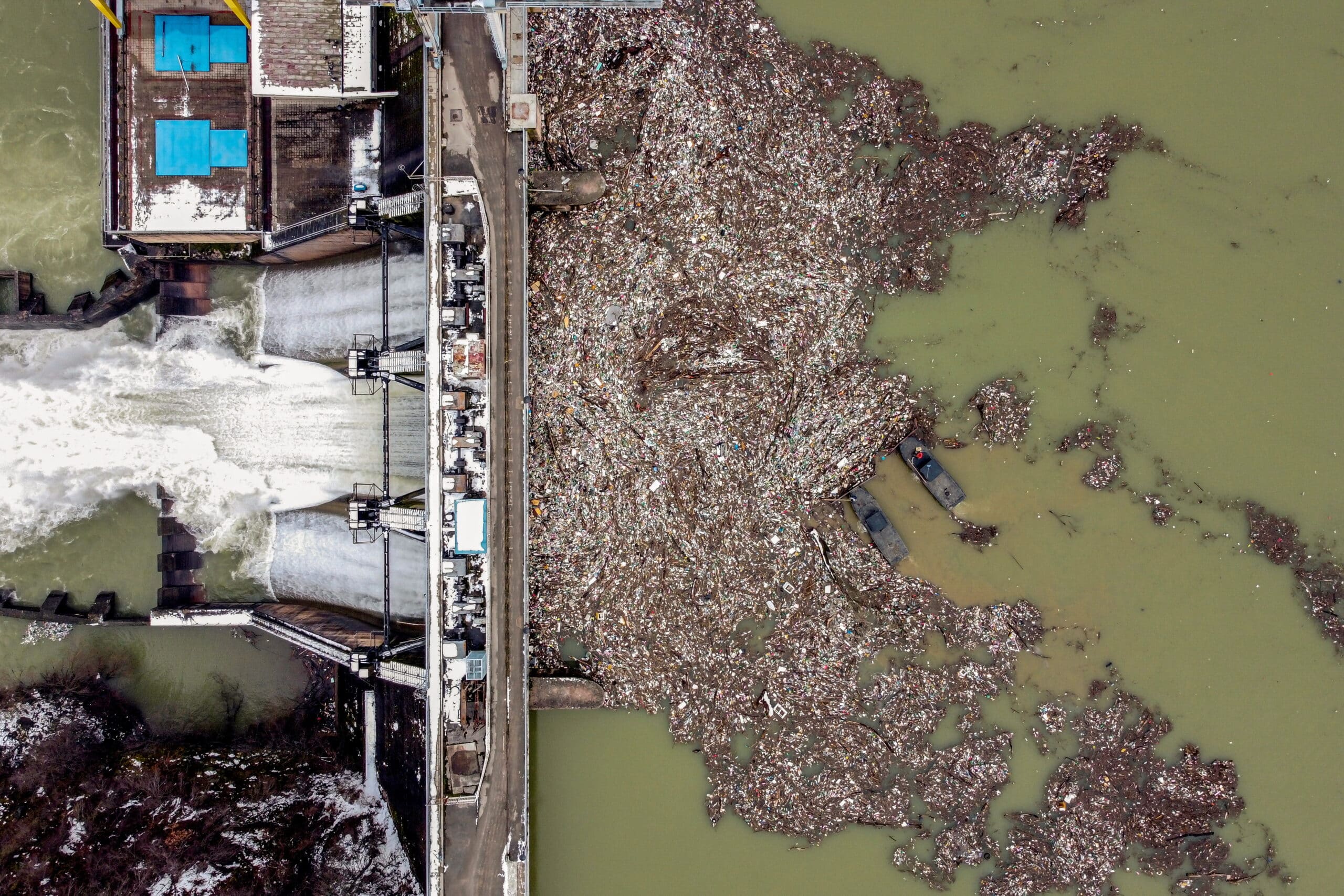 Workers collect plastic that litters the Potpecko Lake near a dam's hydroelectric plant near Priboj, Serbia. The operators collect up to 100 cubic meters of trash daily and take it to a landfill about 80 km (50 miles) away. REUTERS/Marko Djurica