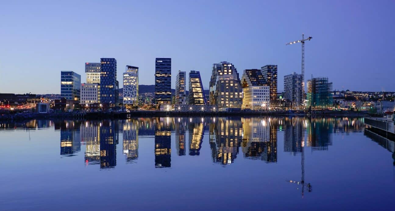 Oslo's Barcode district skyline at dusk, reflected in the water