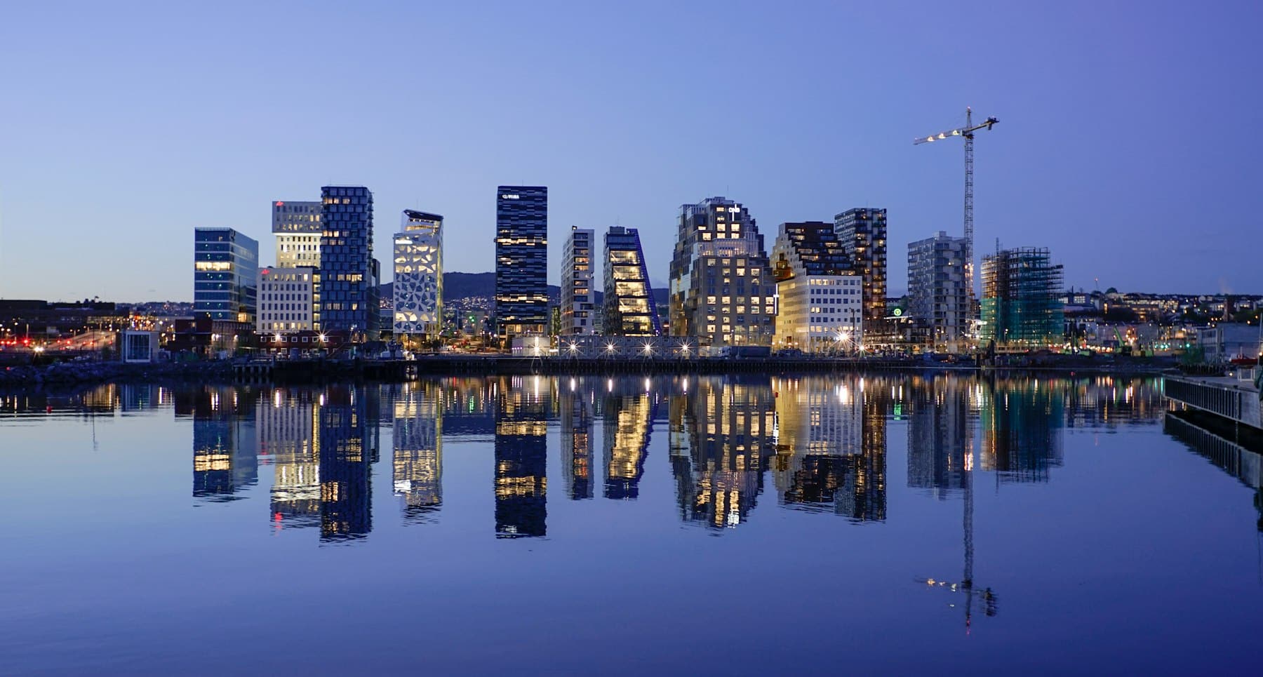 Oslo's Barcode district skyline at dusk, reflected in the water