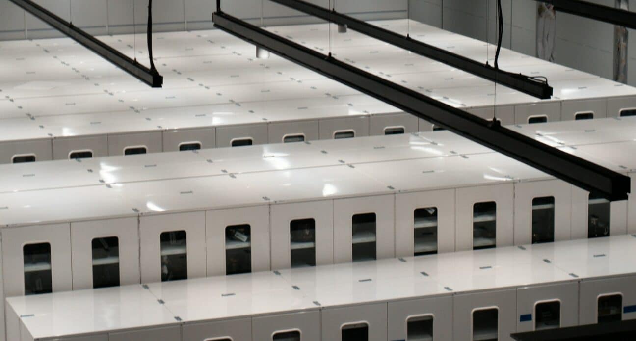 Rows of white server cabinets in a data centre